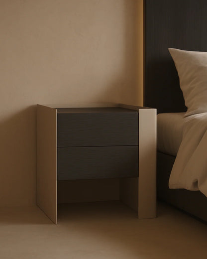 Modern nightstand with two drawers in a minimalistic bedroom setting.