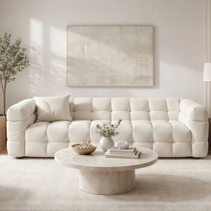 A sculptural, contemporary three-seater in soft boucle, defined by deep channel tufting and a refined low-profile silhouette, ready for quick delivery.