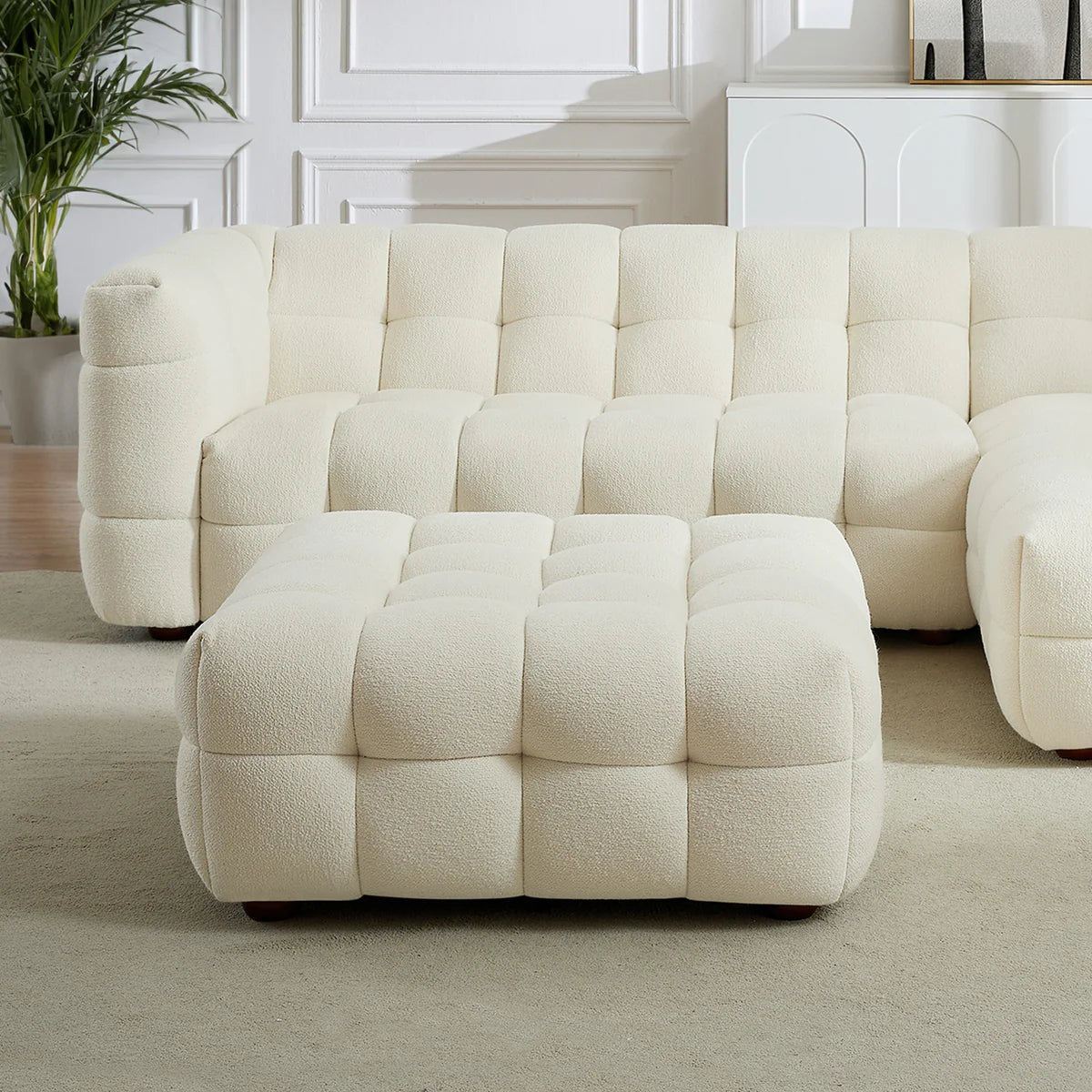 A sculptural, low-profile accent in soft boucle, featuring deep channel tufting and a refined modular design.