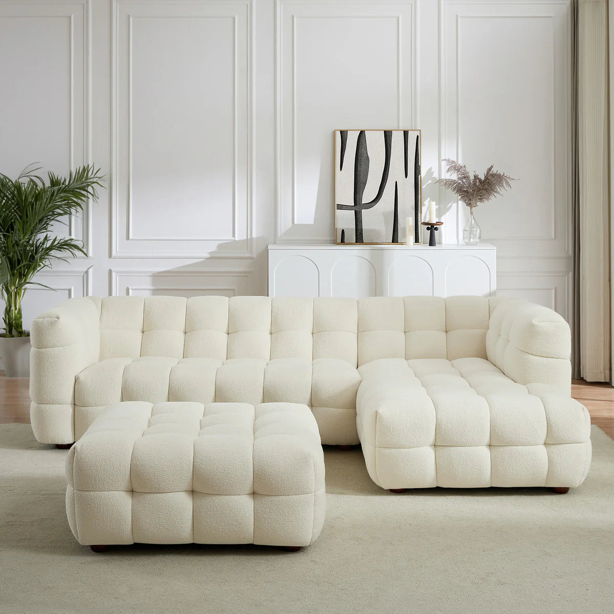 A sculptural, low-profile piece in soft boucle, featuring deep channel tufting and a versatile modular design for added comfort and style.