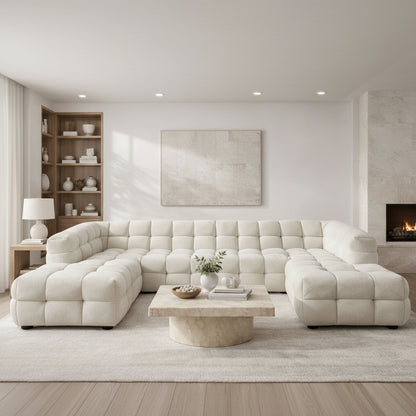 A sculptural, contemporary U-shaped design in soft boucle, featuring deep channel tufting and a spacious layout for refined, modern living.