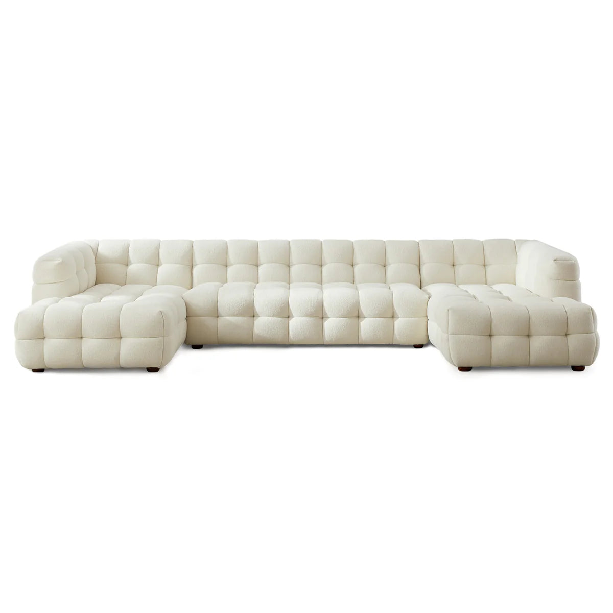 A statement modular design in soft boucle, featuring deep channel tufting and a spacious U-shaped configuration for modern, elevated living.