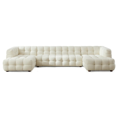 A statement modular design in soft boucle, featuring deep channel tufting and a spacious U-shaped configuration for modern, elevated living.