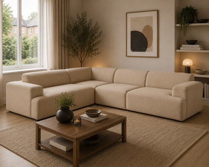 Beige sectional sofa in a living room with a wooden coffee table, plants, and a lamp.