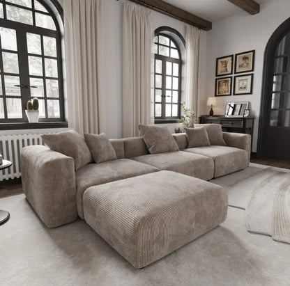 spacious modular sofa with footstool featuring deep cushions and a clean contemporary silhouette
