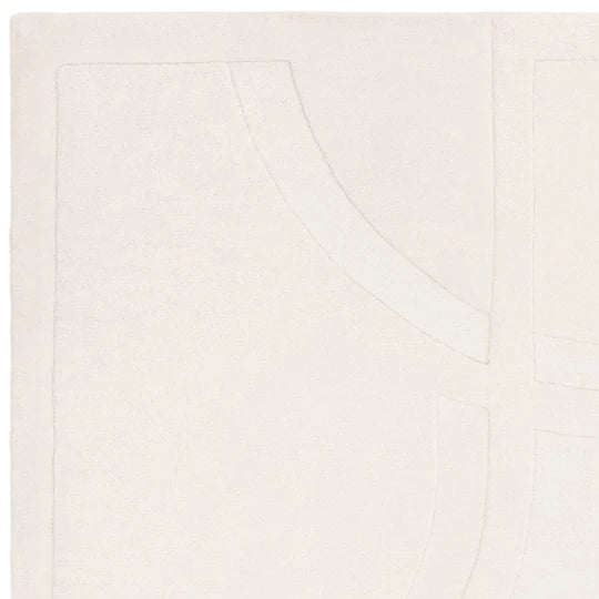 An angled detail shot showcasing the refined edge finishing and expert wool craftsmanship of the Marcella Rug, highlighting durability and clean construction on a white background.