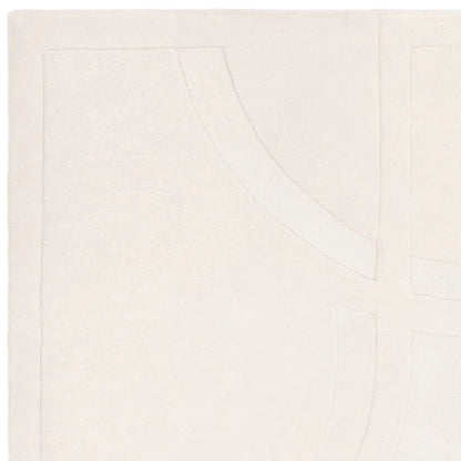 An angled detail shot showcasing the refined edge finishing and expert wool craftsmanship of the Marcella Rug, highlighting durability and clean construction on a white background.