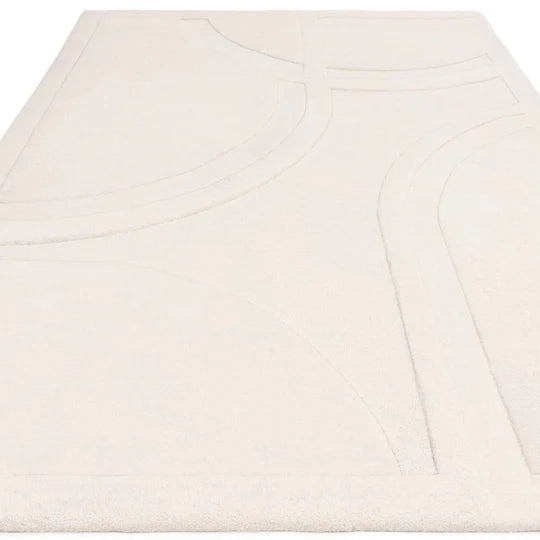 A studio angled view capturing the Marcella Rug’s subtle tonal variation, soft ivory finish, and natural wool surface texture under controlled lighting.