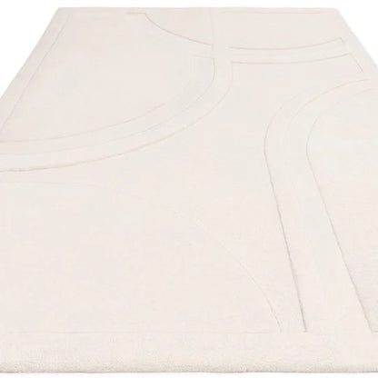 A studio angled view capturing the Marcella Rug’s subtle tonal variation, soft ivory finish, and natural wool surface texture under controlled lighting.