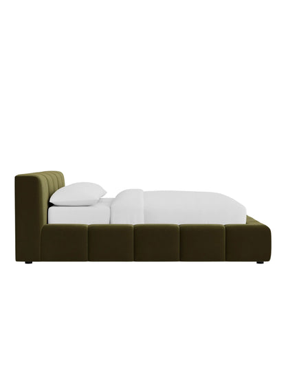 Side angle of Miles bed highlighting wraparound frame and deep cushioned panel detailing