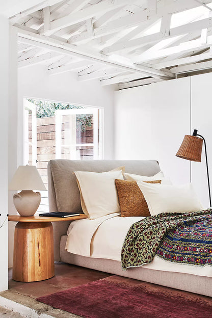modern upholstered bed with neutral fabric and calm aesthetic