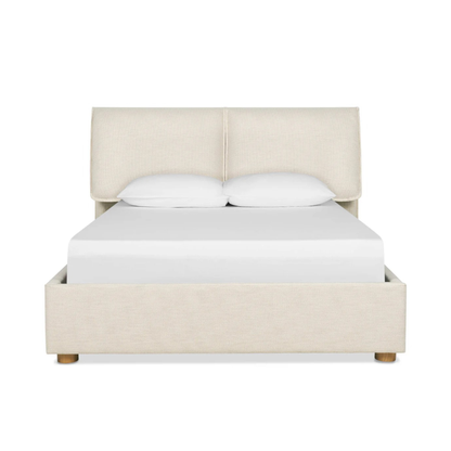 nomad bed with upholstered headboard and soft neutral fabric