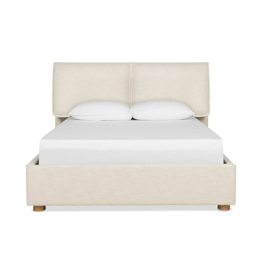 nomad bed with upholstered headboard and soft neutral fabric