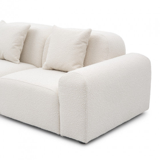 compact modular two seater sofa with clean lines and soft upholstered cushions
