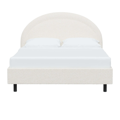 modern bed with a rounded headboard and clean silhouette