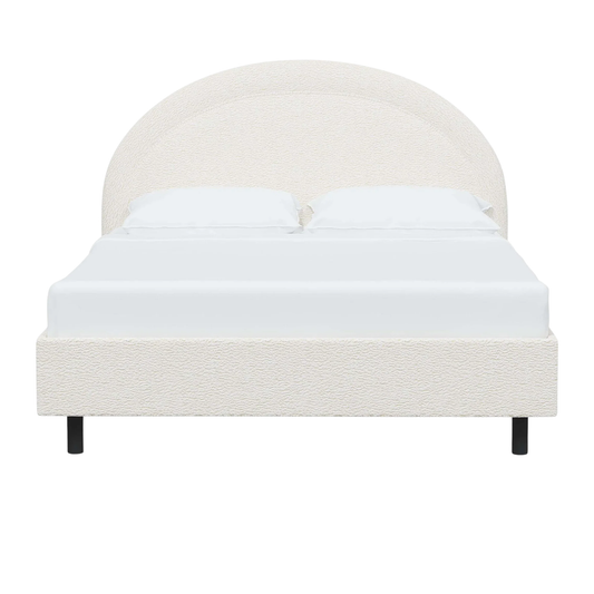 modern bed with a rounded headboard and clean silhouette