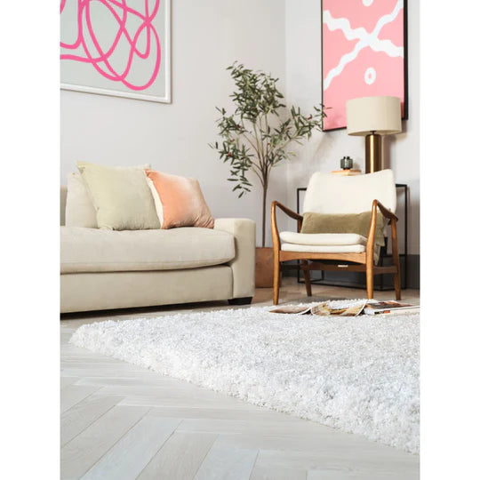 A detailed close-up showcasing the Rosera Rug’s hand woven construction in off white, emphasizing natural fibre variation, soft texture, and subtle tonal depth against a white studio background.