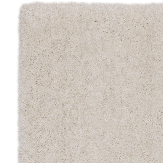 An angled studio shot capturing the Rosera Rug’s understated off white weave pattern, natural texture variation, and artisanal character on a white background.