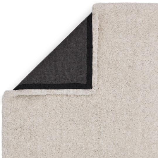 This image focuses on the refined edge finishing of the Rosera Hand Woven Rug, highlighting precise craftsmanship and durable woven construction on a clean white background.