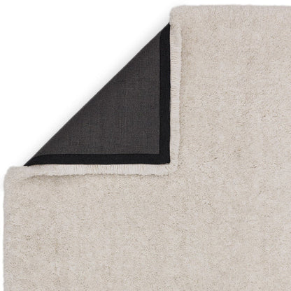 This image focuses on the refined edge finishing of the Rosera Hand Woven Rug, highlighting precise craftsmanship and durable woven construction on a clean white background.