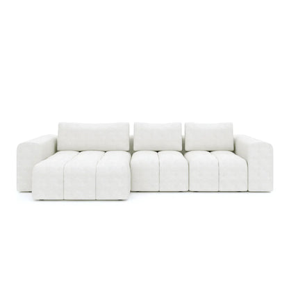 A white modular L-shaped three-piece sofa with a sleek 1-arm seat, a single seat, and a chaise.