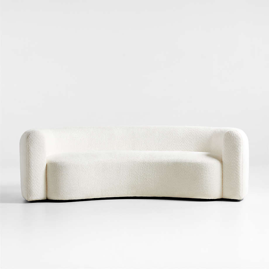 A beige, fabric-covered sofa with a solid hardwood frame and hidden black plastic legs, presented in a curved, streamlined style.
