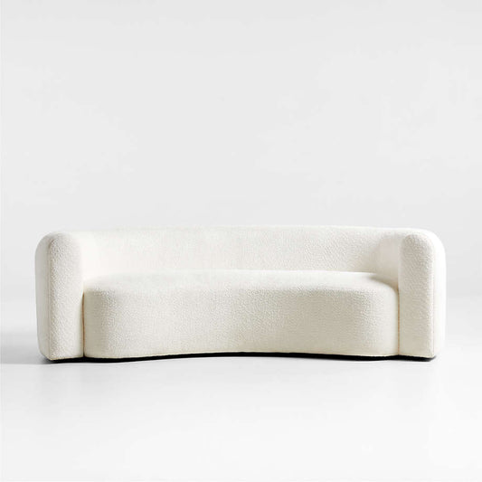A beige, fabric-covered sofa with a solid hardwood frame and hidden black plastic legs, presented in a curved, streamlined style.