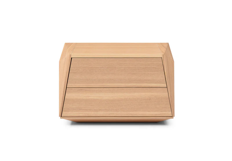 The Vertu Bedside Table is presented in a full studio view on a clean white background, showcasing its angular silhouette and refined ash oak veneer finish.